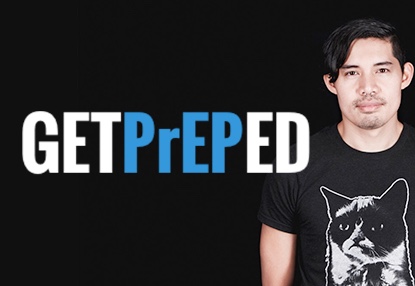 From a black background, a male figure, visible from the waste up, stands out in black Grumpy Cat tee, his left arm cropped out of the image. In simple white and blue block letters, the text arrayed across the image says “get PrEPed,” the “Get” and “Ed” in white while the “PrEP” is a telltale blue.